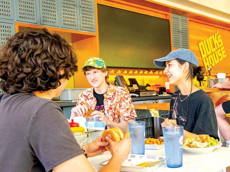 Students eat together inside Duck's House.