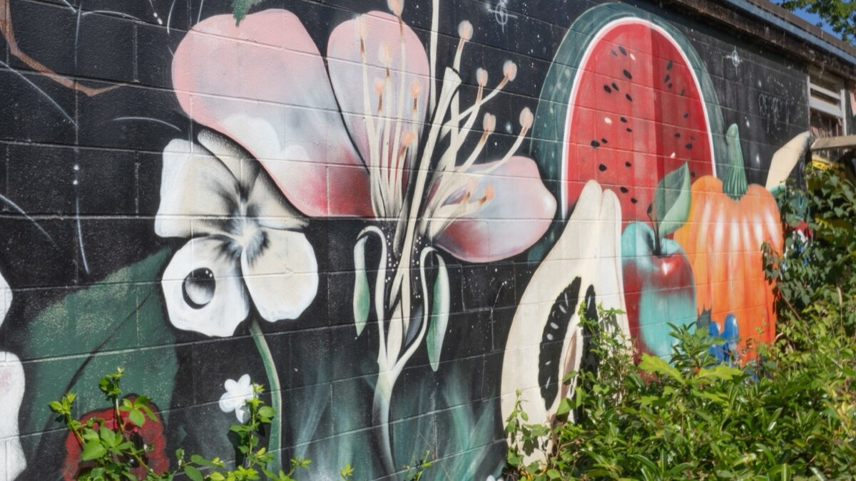 A flower mural brightens an exterior wall in Eugene.