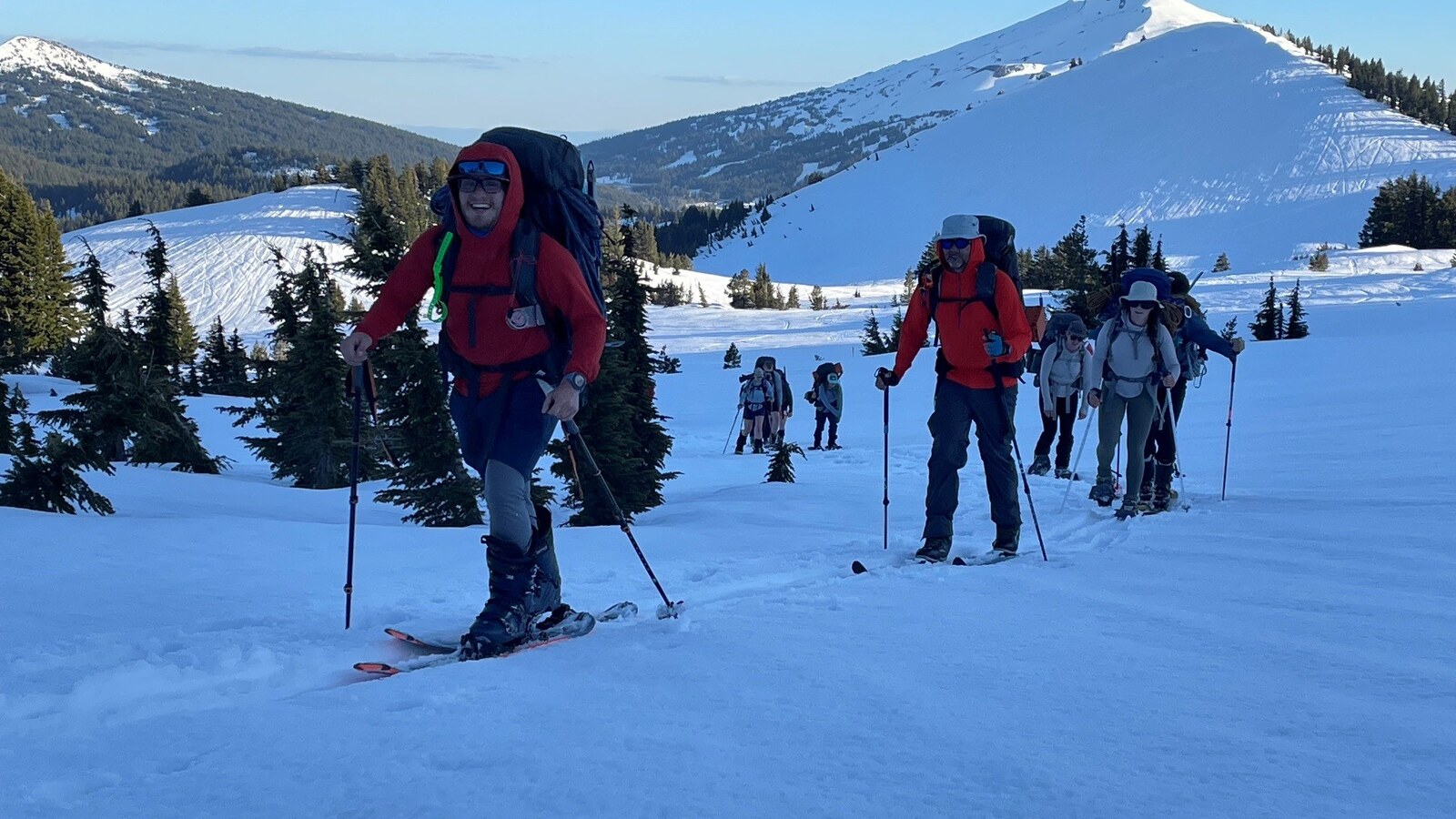 Students snowshoe across a mountain.