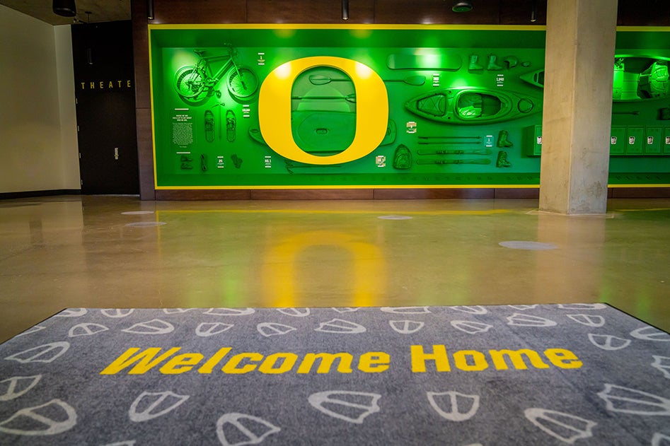 The interactive Gear Wall in the Student Welcome Center, with a lit O and outdoor equipment.