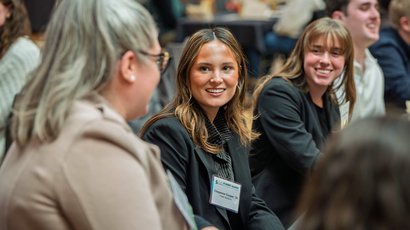 Alumni talk together at a professional networking event.